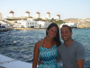 woman and man posing next to waterfront