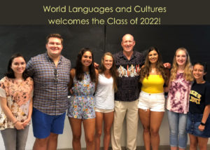 students posing together with a welcome class of 2022 sign